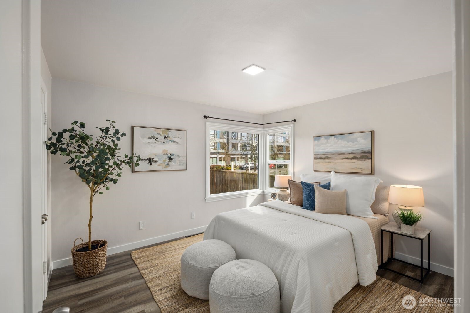 6023 35th Avenue Southwest Seattle, WA 98126 - Photo 16 of 38 a bedroom with a bed and a potted plant