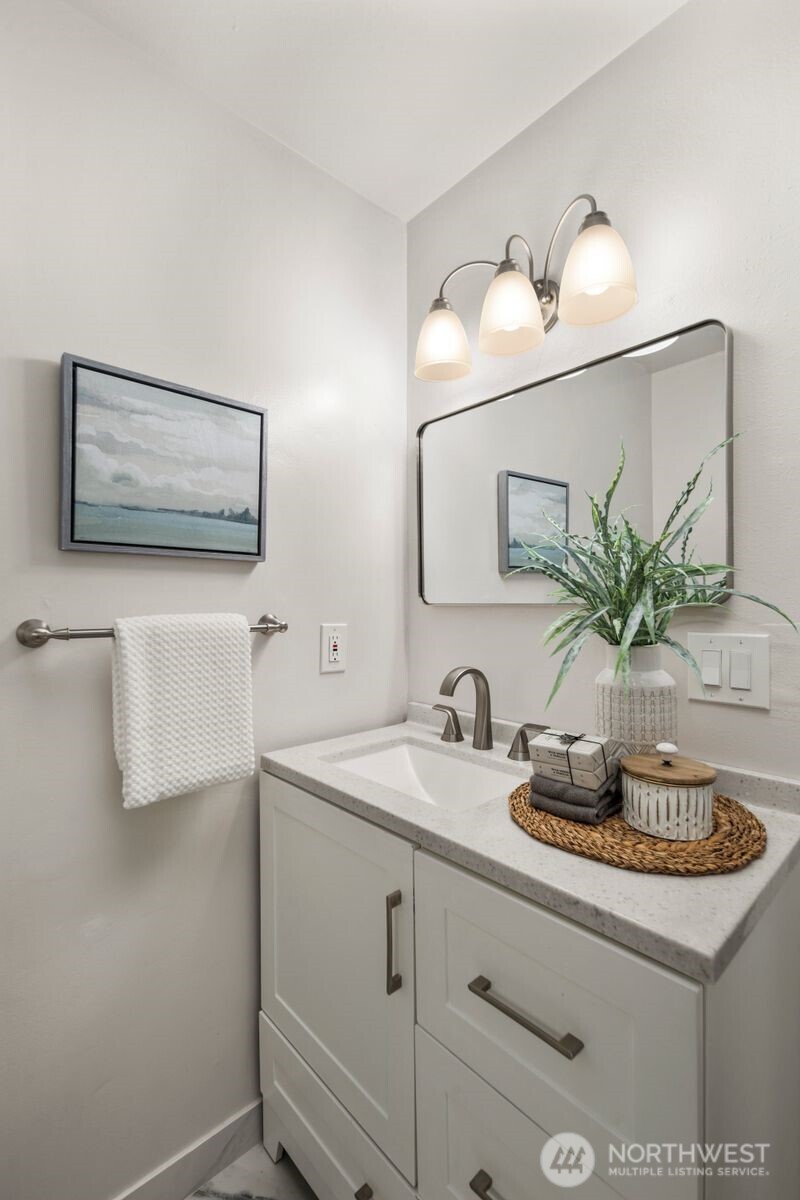 6023 35th Avenue Southwest Seattle, WA 98126 - Photo 19 of 38 a bathroom with a sink and a mirror