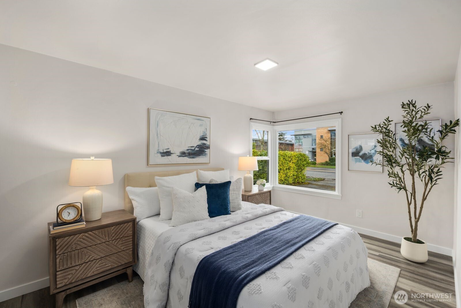 6023 35th Avenue Southwest Seattle, WA 98126 - Photo 20 of 38 a bedroom with a bed and a potted plant