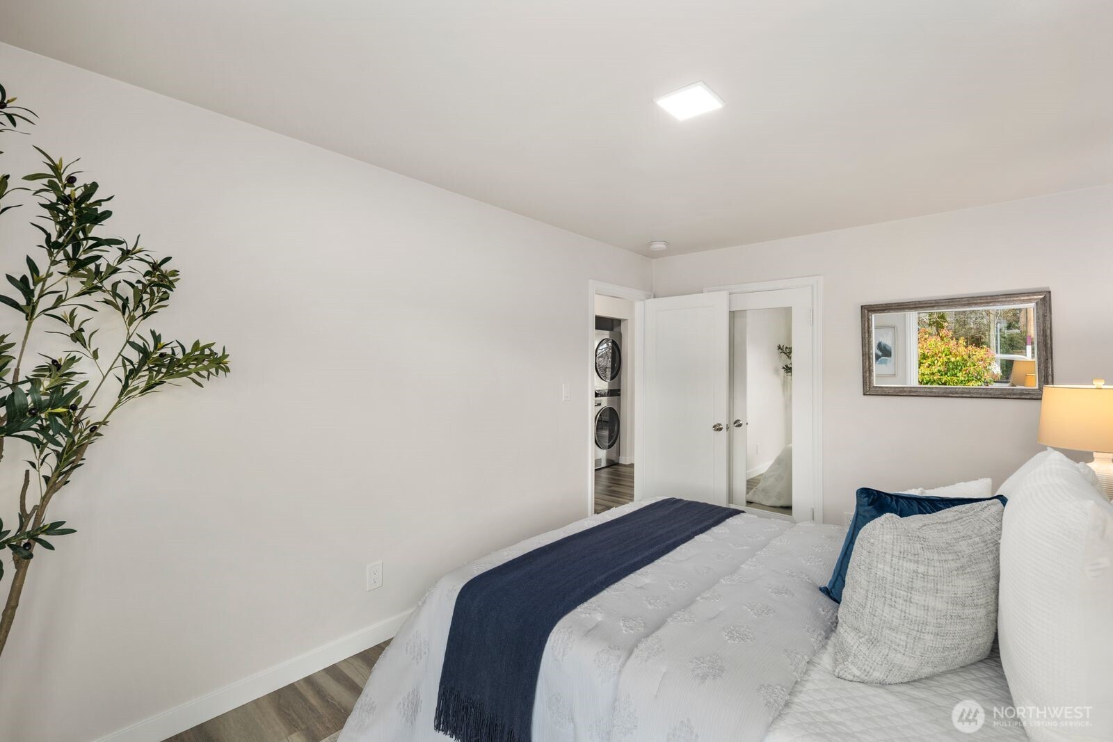 6023 35th Avenue Southwest Seattle, WA 98126 - Photo 21 of 38 a bedroom with a bed and a painting on the wall