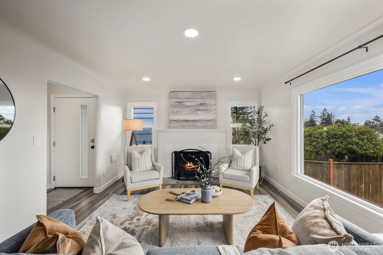 6023 35th Avenue Southwest Seattle, WA 98126 - Photo 8 of 38 a living room with furniture a fireplace and a floor to ceiling window