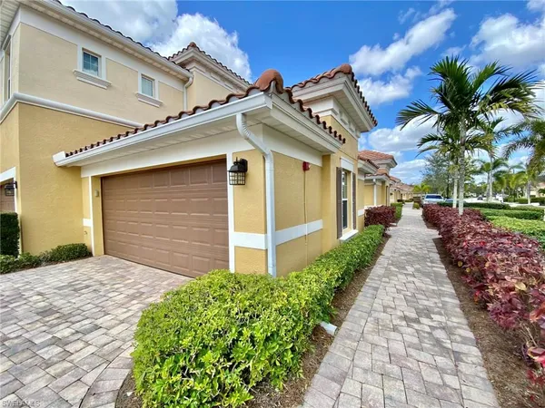 a front view of house with yard and trees around