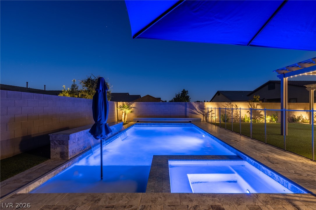 7036 Arabian Ridge Street Las Vegas, NV 89131 - Photo 56 of 64 Sparkling pool and spa with an automated cover, cantilever umbrella, and safety fence perfect for escaping those hot summer days.