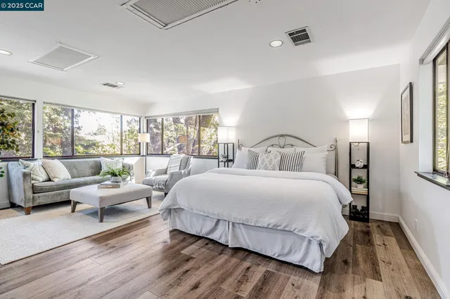 a bedroom with a bed and large window