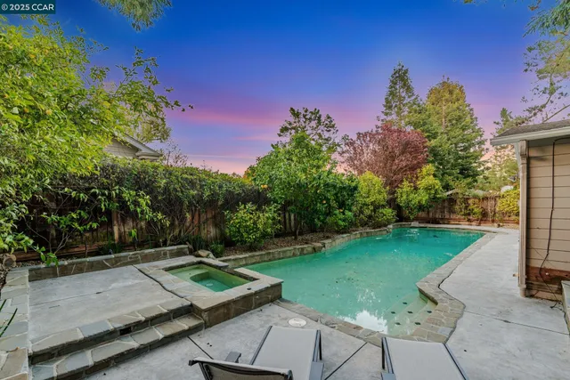 a view of a backyard with sitting area
