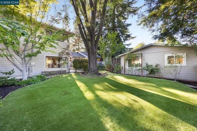a view of a house with a backyard
