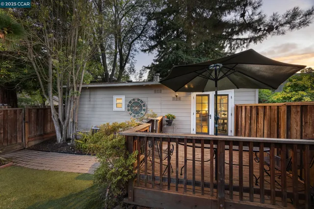 a view of a wooden deck next to a yard