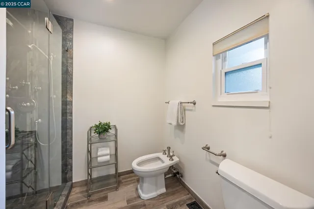 a bathroom with a toilet a sink and shower