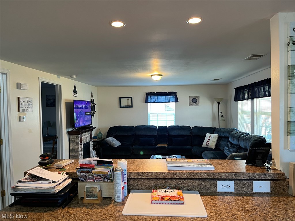 4972 West Fremont Road Port Clinton, OH 43452 - Photo 5 of 29 Living room featuring a wealth of natural light and dark carpet