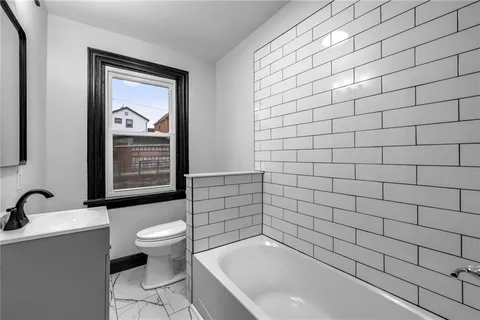 a bathroom with a bathtub and sink