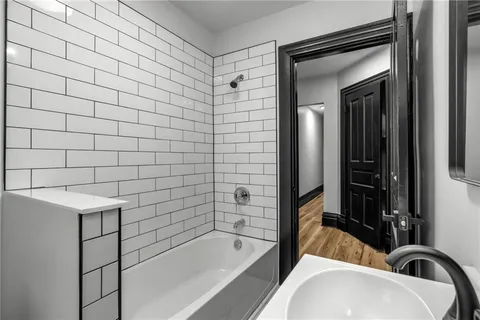 a bathroom with a bathtub and a shower