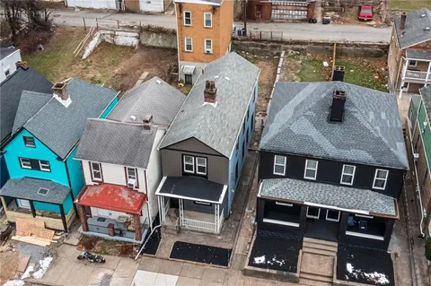 an aerial view of a brick building with many windows