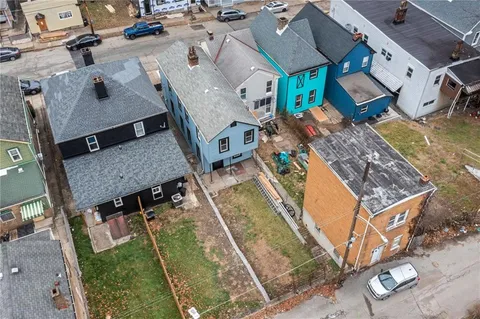 an aerial view of a house with a swimming pool