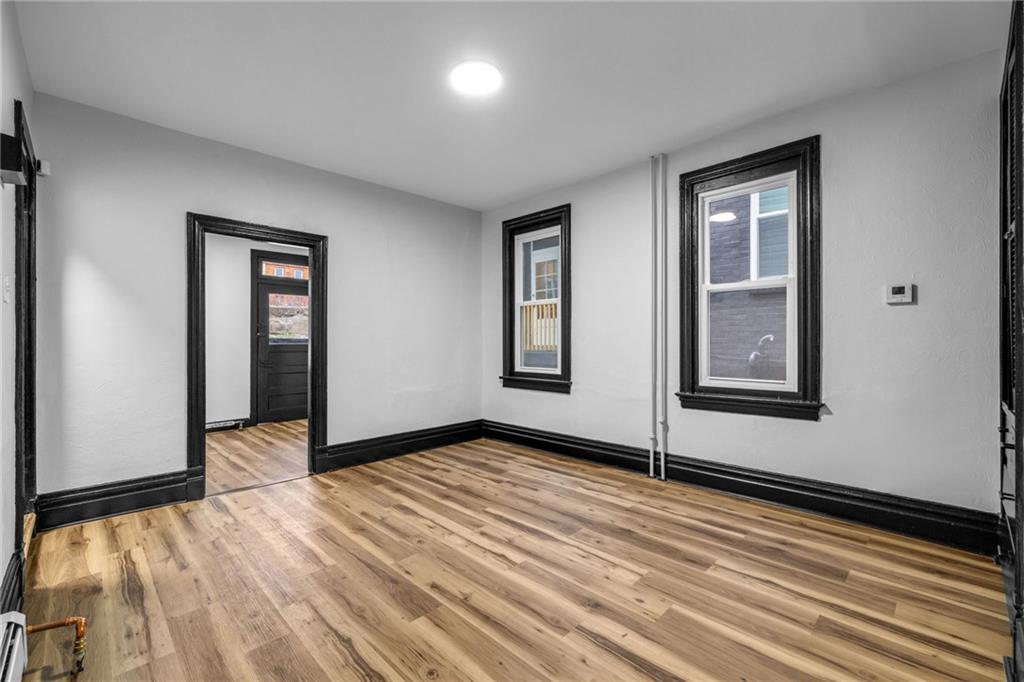 222 East 16th Avenue Homestead, PA 15120 - Photo 8 of 28 a view of an empty room with wooden floor and closet