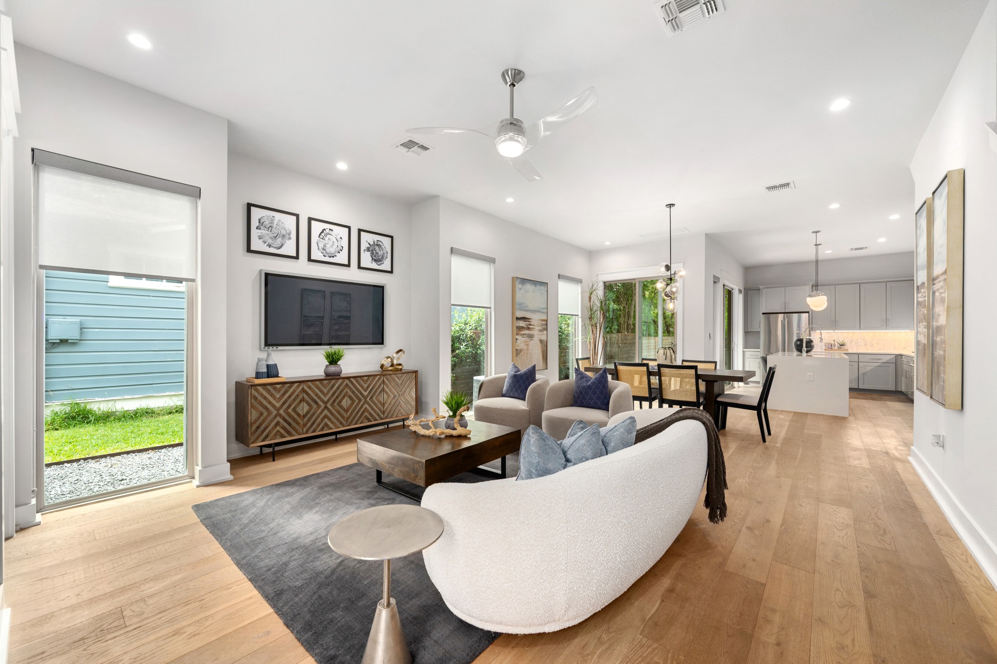 An open-concept interior features polished hardwood floors and high ceilings, ideal for modern living.