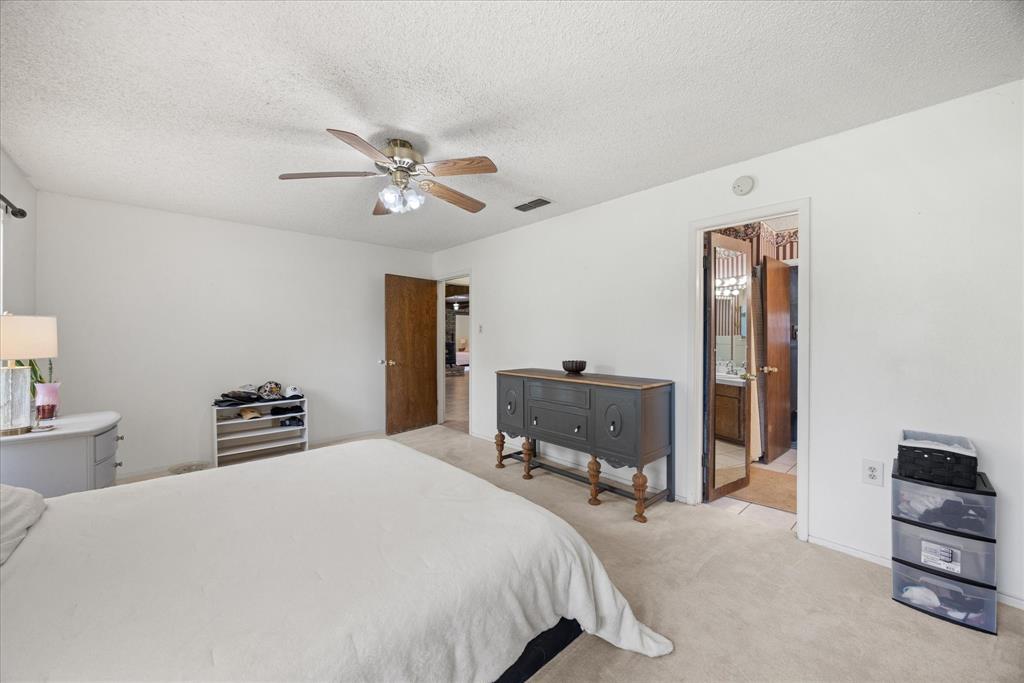 4210 Waples Road Granbury, TX 76049 - Photo 29 of 37 Bedroom featuring neutral carpeting, white walls, and a ceiling fan with light fixture