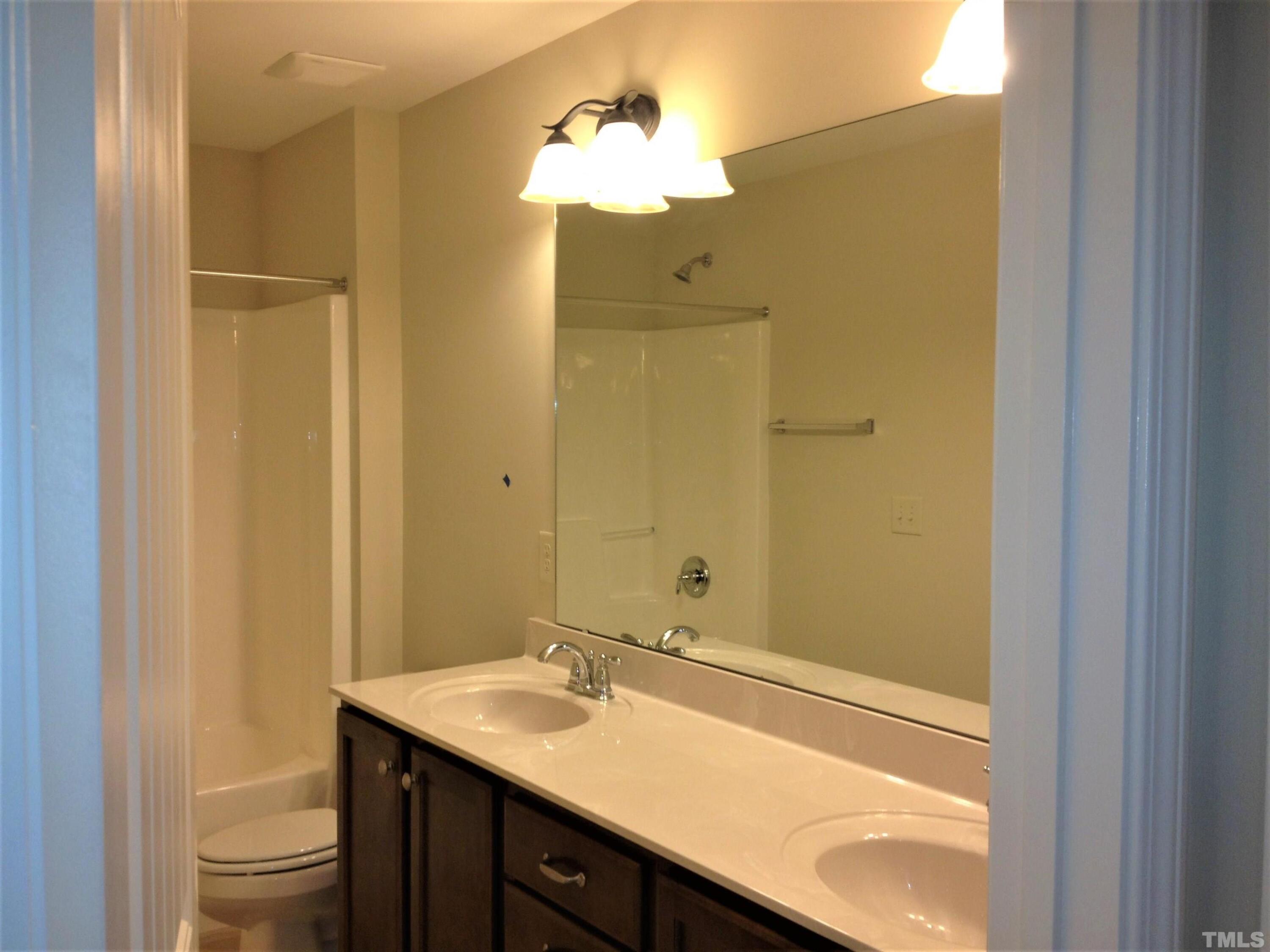 226 Skyros Loop Cary, NC 27519 - Photo 11 of 14 a bathroom with a sink and a mirror