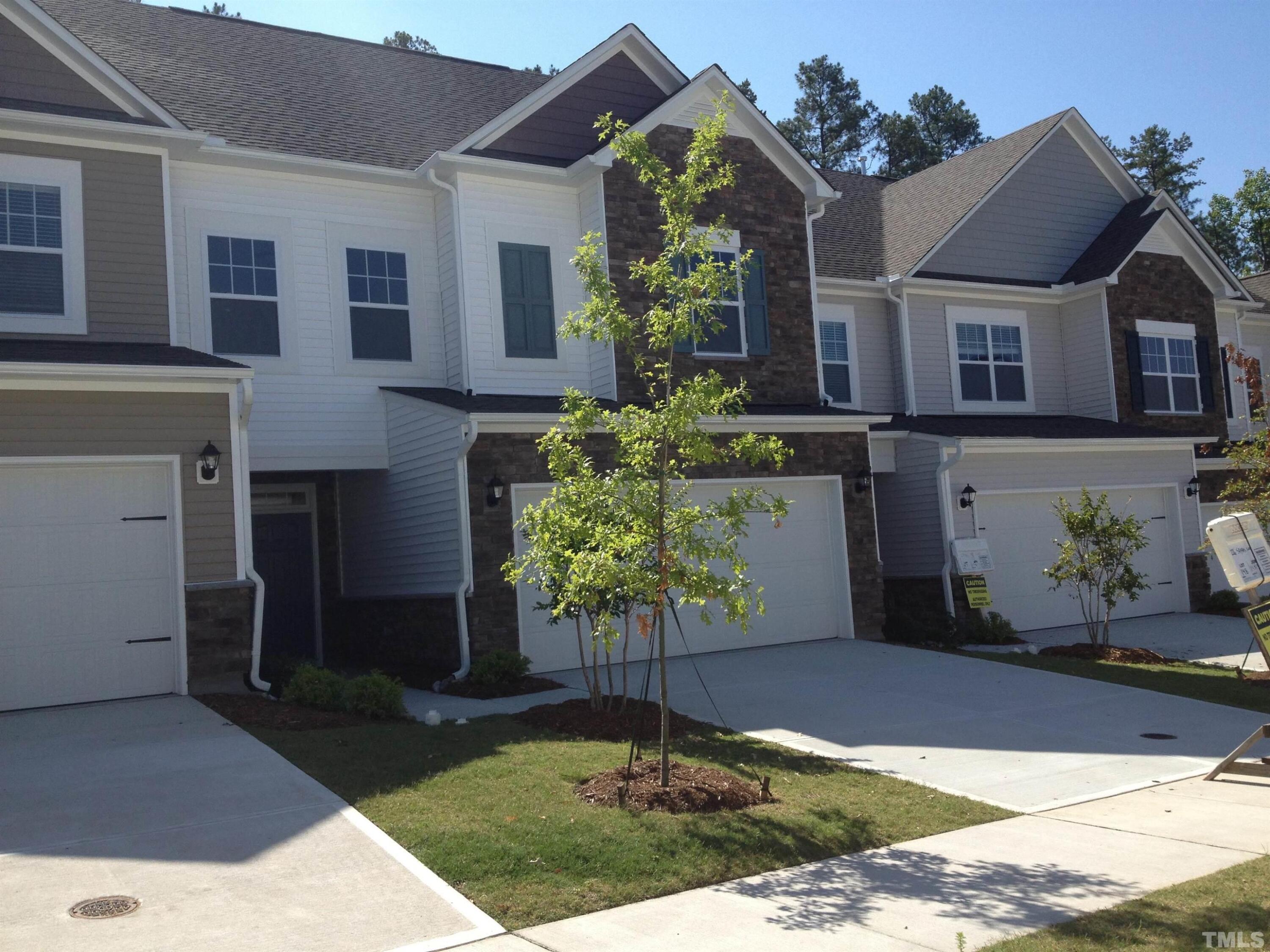 226 Skyros Loop Cary, NC 27519 - Photo 13 of 14 a front view of a house with garden