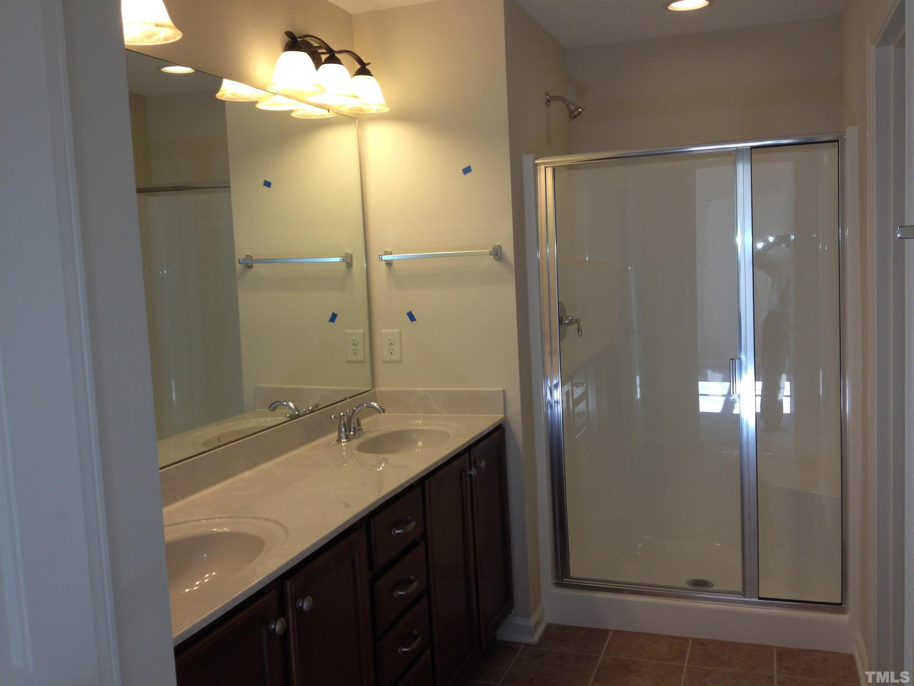 226 Skyros Loop Cary, NC 27519 - Photo 10 of 14 a bathroom with a shower sink vanity granite and shower