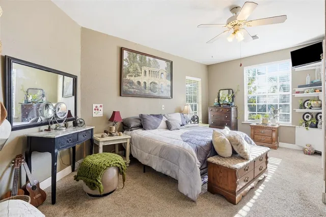 a spacious bedroom with a bed and a chandelier