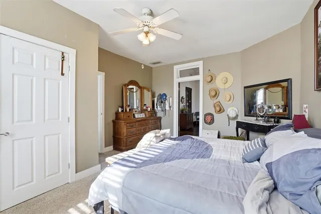 a bed room with a bed mirror and a window