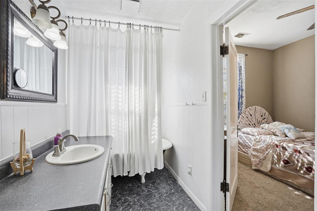 114 S Field Cleburne, TX 76033 - Photo 13 of 23 a bathroom with a sink and a window