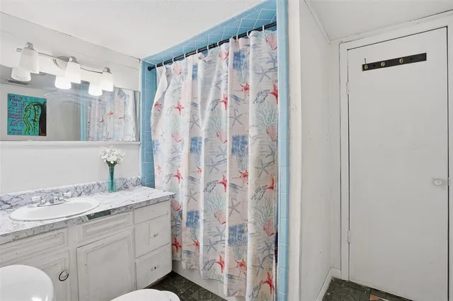 a bathroom with a sink a vanity and a shower