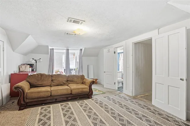 a spacious bedroom with a bed and a couch