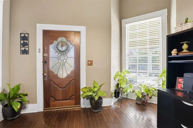 a vase of flowers sitting on a wooden floor