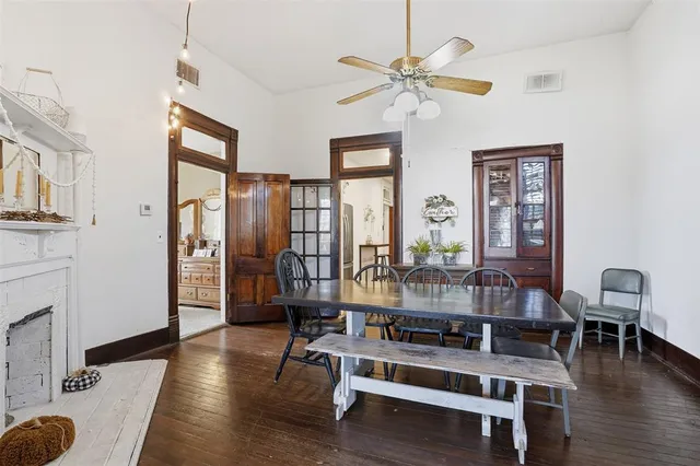 a living room with fireplace furniture and wooden floor