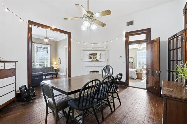 a view of a a dining room and livingroom with furniture wooden floor a chandelier