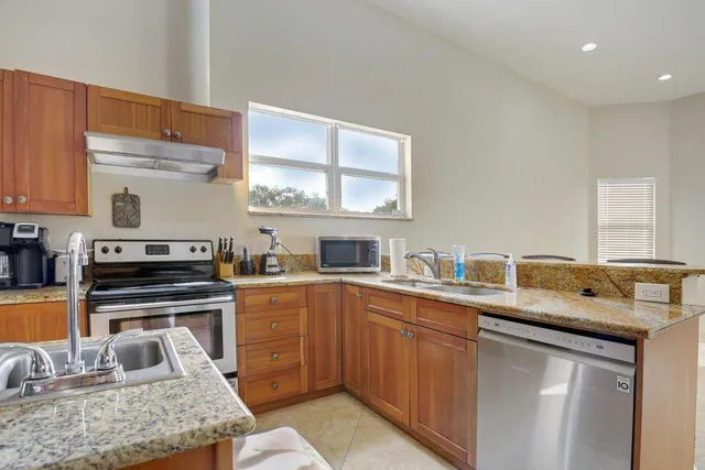 a kitchen with a sink stove and microwave