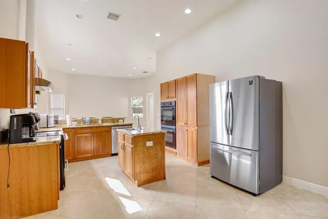 a kitchen with refrigerator and stove
