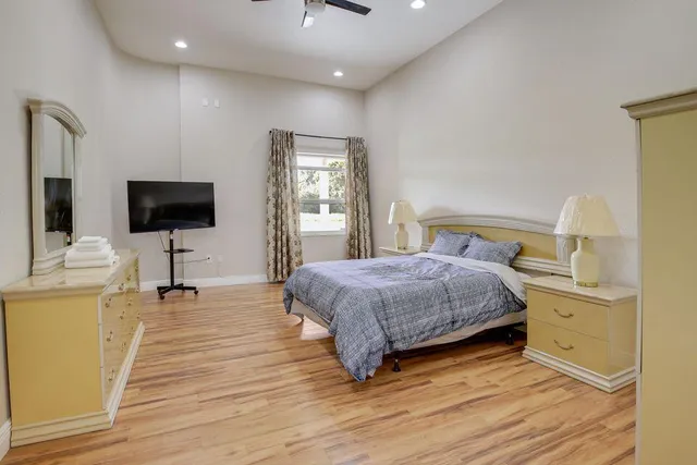 a bedroom with a bed and a flat screen tv