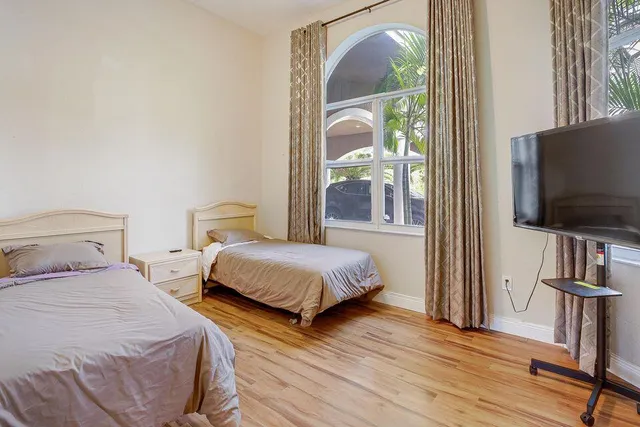 a bedroom with two beds and a flat screen tv