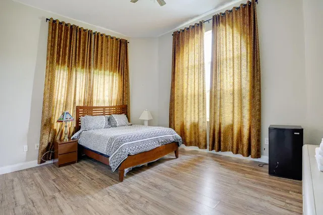 a spacious bedroom with a bed and a window