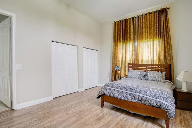 a bedroom with a bed and a window