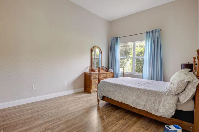 a bed sitting in a bedroom next to a window