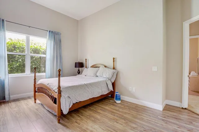 a bed sitting in a bedroom next to a window