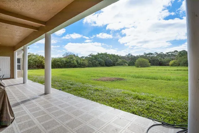 a view of a house with backyard porch and sitting area