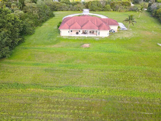 a swimming pool with outdoor seating and yard