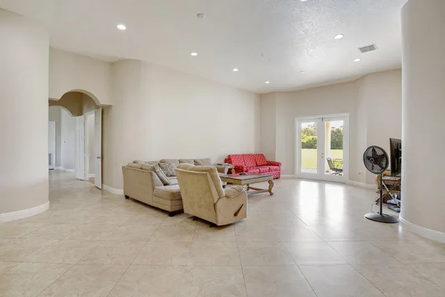 a living room with furniture and a gym machine