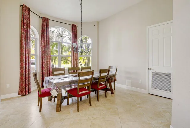 a view of a dining room with furniture and a window