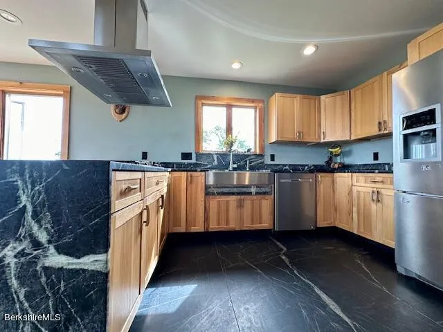 a view of a kitchen with stainless steel appliances granite countertop a stove and a sink