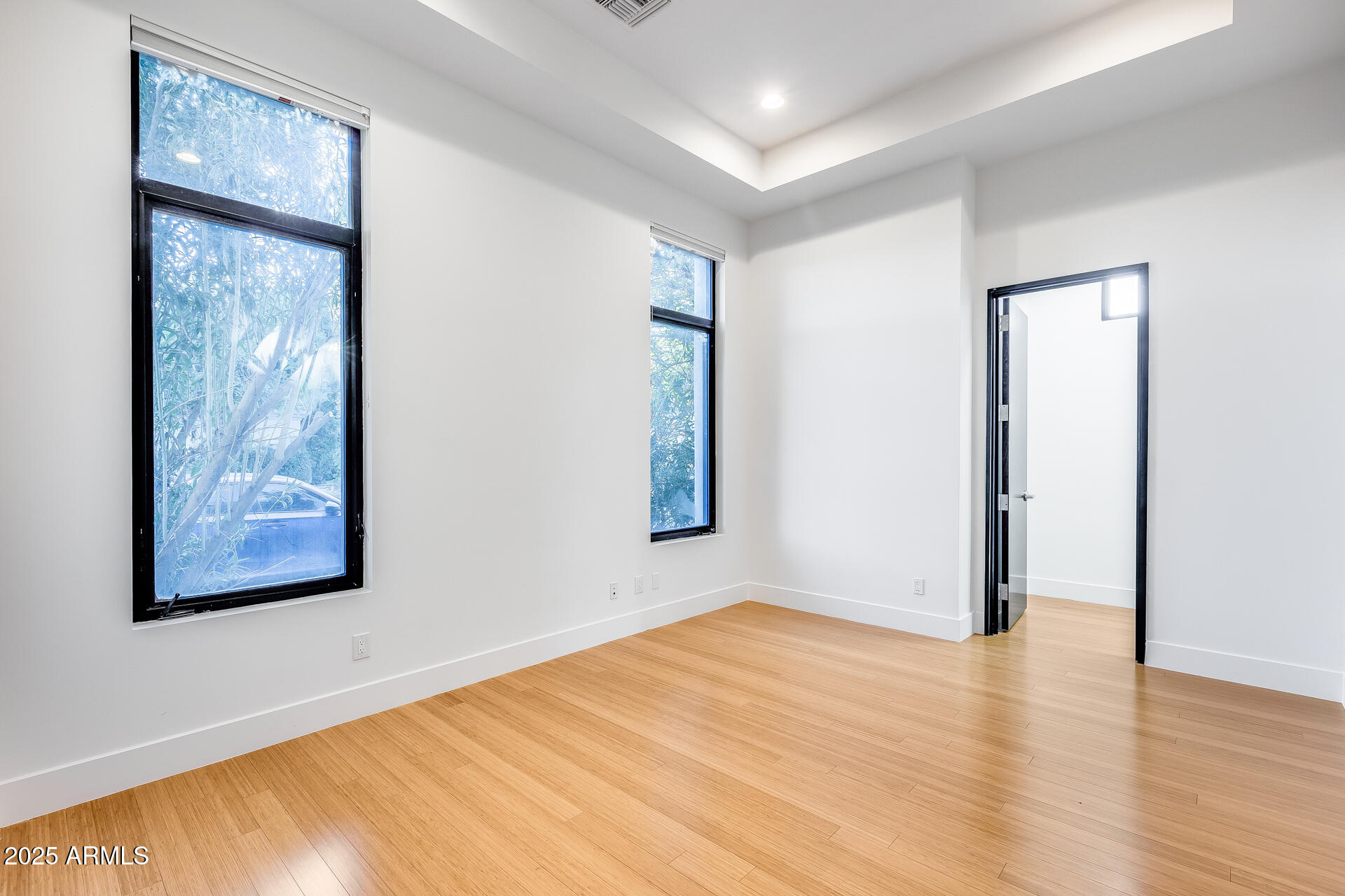 1101 East Warner Road, Unit 117 Tempe, AZ 85284 - Photo 25 of 69 an empty room with wooden floor and windows