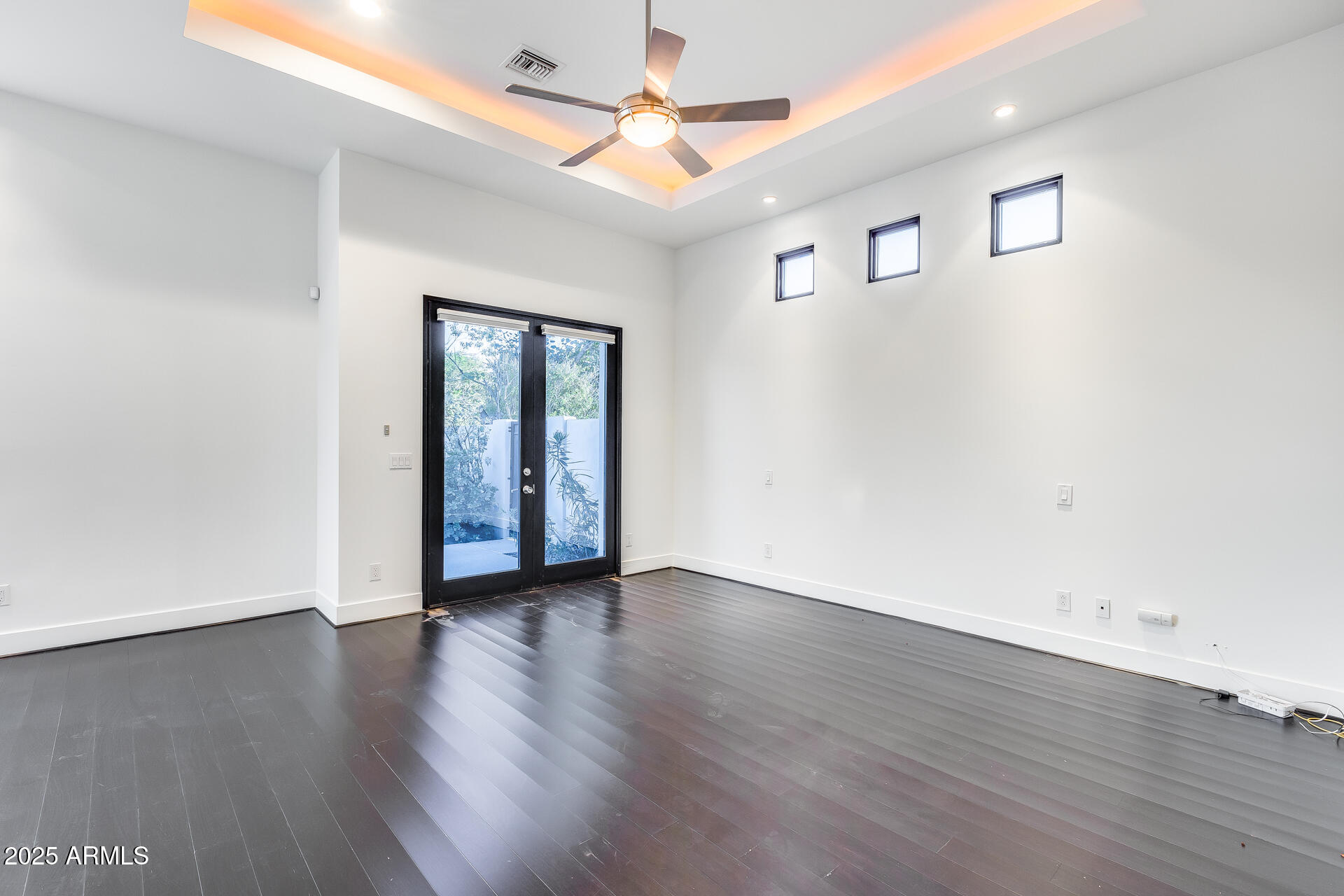 1101 East Warner Road, Unit 117 Tempe, AZ 85284 - Photo 29 of 69 an empty room with wooden floor chandelier fan and windows