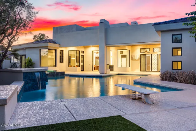 a view of a house with pool and a yard