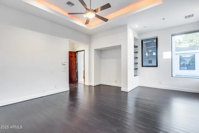 a view of a house with pool and chairs next to a yard