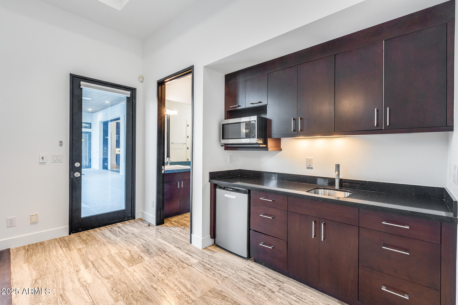 1101 East Warner Road, Unit 117 Tempe, AZ 85284 - Photo 47 of 69 a kitchen with a sink and wooden cabinets