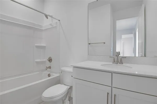 a bathroom with a sink toilet vanity and shower